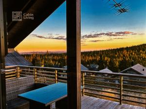 a view from the balcony of a house with a blue bench at Modern New Sports Chalet at Sjusjøen in Ringsaker