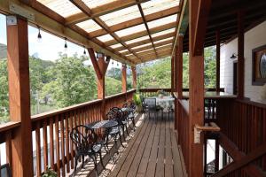 a wooden deck with tables and chairs on it at Mariposa Hotel Inn in Mariposa