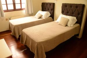 A bed or beds in a room at Altos da Serra Hotel