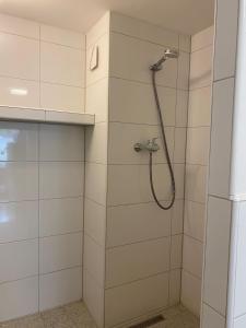 a bathroom with a shower with a shower head at Hüls Central Apartment in Marl