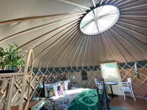 a room with a bed in a yurt at Thistlebank Yurt in Llangollen