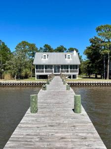 a house on a dock in the middle of the water at Write on the Bay, a Waterfront Retreat in Coastal Alabama in Fairhope