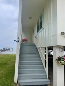 a staircase leading up to a house with the beach at Write on the Bay, a Waterfront Retreat in Coastal Alabama in Fairhope