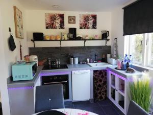 a kitchen with purple counters and a white appliance at Apartment Melanie in Hovmantorp