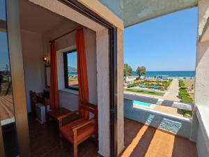 a room with a window and a view of the ocean at Hotel Tsagarakis Beach in Amoudara Herakliou