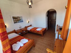 a hotel room with two beds and a hallway at Hotel Tsagarakis Beach in Amoudara Herakliou
