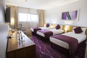 Rúm í herbergi á Louis Fitzgerald Hotel