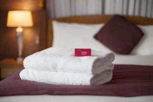 Rúm í herbergi á Louis Fitzgerald Hotel