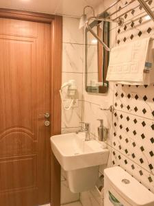 La salle de bains est pourvue d'un lavabo, de toilettes et d'un miroir. dans l'établissement Sultanahmet Nu Hotel, à Istanbul