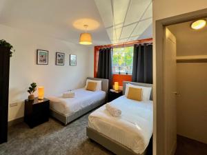 1 dormitorio con 2 camas y ventana en Curzon House One - Great for Contractors or Family Holidays en Cleethorpes