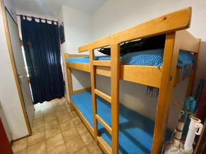 a room with two bunk beds with blue sheets at Appartement La Clusaz, 2 pièces, 6 personnes - FR-1-459-34 in La Clusaz