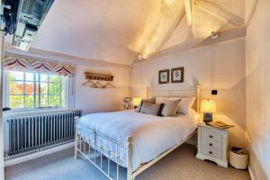 a bedroom with a bed and a window at The Woolpack Inn in Coggeshall
