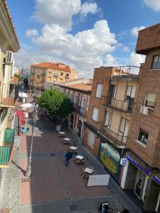 a person walking down a city street with buildings at Home JV in Getafe