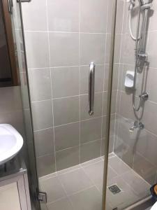 a shower with a glass door in a bathroom at Condotel Type in Manila