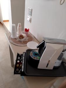 a coffee maker sitting on top of a table at B&B Fiore in Gallipoli