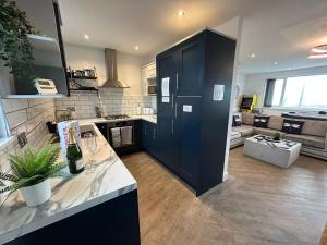 a kitchen with a large black cabinet in a room at Seaview House in Cleveleys