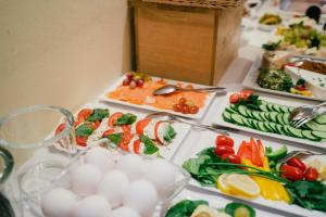 a table topped with different types of food on plates at Altstadt Hotel St. Georg in Düsseldorf