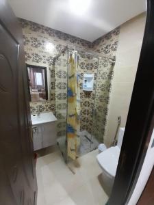 a bathroom with a shower and a toilet and a sink at Residence vip in Nador