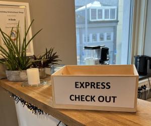 a box with a sign that reads express check out at Bodø Hostel & Motel in Bodø