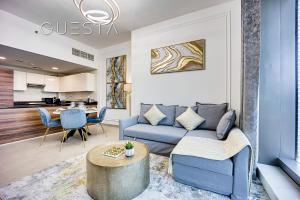 a living room with a couch and a table at Sparkle Tower, Dubai Marina in Dubai