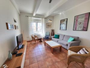a living room with a couch and a tv at Apartment Sablicevo - Near the Beach in Rijeka
