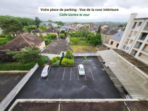 a parking lot with two cars parked in it at Le Cosy Gaillard 3 étoiles, magnifique vue sur la ville, parking privé et proche du centre in Brive-la-Gaillarde