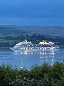 a large cruise ship sitting in the water at clyde hub in Gourock