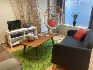 a living room with a couch and a table at Gîte d'Avalon Appartement 5 in Dinant