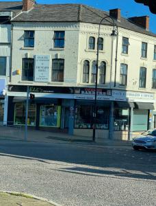 a building on the corner of a street at Fountains Hotel Runcorn in Runcorn