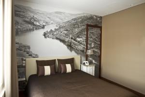 Uma cama ou camas num quarto em Ribeira do Porto Hotel
