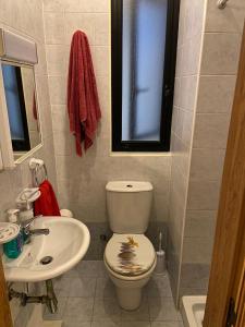 a bathroom with a toilet and a sink at Cristina Home in St Paul's Bay