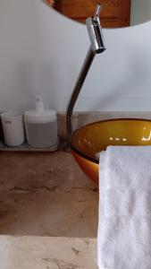 uma casa de banho com um lavatório com uma toalha e um candeeiro em Casa D´Alicia em Maraú