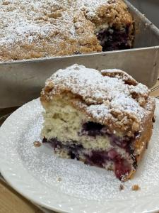 a piece of blueberry cake on a white plate at Brass Lantern Inn in Stowe