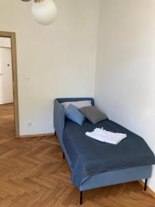 a bedroom with a blue bed with a mirror at Apartament z klimatyzacją in Krakow