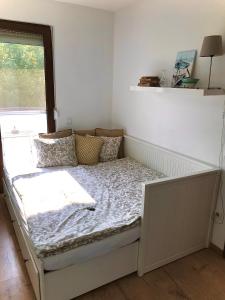 a bed sitting in a room with a window at Erkel 19 Apartmanház in Keszthely +84 photos