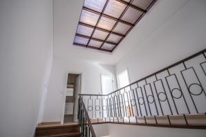 a hallway with a staircase with a skylight at 188 Apartments - Estrelícia - pool and balcony in Cascais