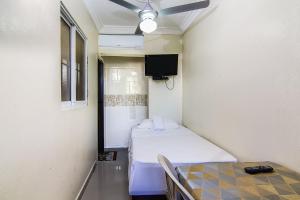 a hospital room with two beds and a tv at Tropical Island Aparthotel, Budget Rooms & Family Apartment Rentals in Santo Domingo