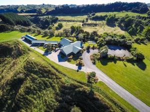 an aerial view of a large house on a grassy field at Makoura Lodge in Apiti