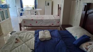 a bedroom with two beds with towels on it at Casa taina in Jarabacoa