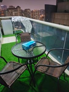 a table and chairs on a balcony with a view at GRACE BEDSPACE, HOSTEL AND ACCOMODATIONS in Dubai