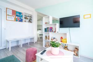 a living room with a tv and a table at Apartment Ingrid in Dubrovnik