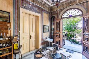 a room with a door and a table with books at Büyükada Anastasia Meziki History Mansion in Buyukada