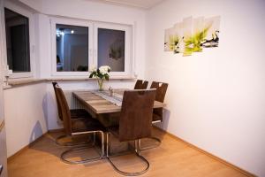 a dining room with a wooden table and chairs at Große Wohnung, 100 qm mit Terrasse in Alzenau in Unterfranken