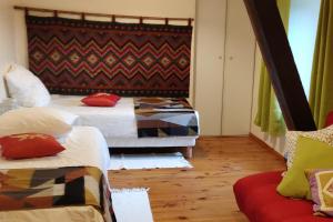 a bedroom with two beds and a couch at La Ciboulette in Foix