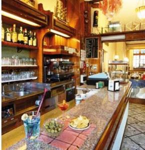 a kitchen with a bar with a drink on a counter at Hotel Elena in Stresa