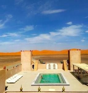 a swimming pool in the middle of the desert at Dar Morocco in Merzouga