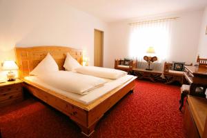Hotel Pfauen في أومكيرش: غرفة نوم بسرير كبير وسجادة حمراء