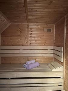 a sauna with a bed with two towels on it at Dům na Lipně in Lipno nad Vltavou