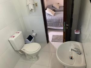a bathroom with a toilet and a sink and a mirror at Las Salinas Hostal in Luque