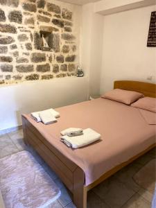 a bedroom with a bed with towels on it at zolina in Tivat
